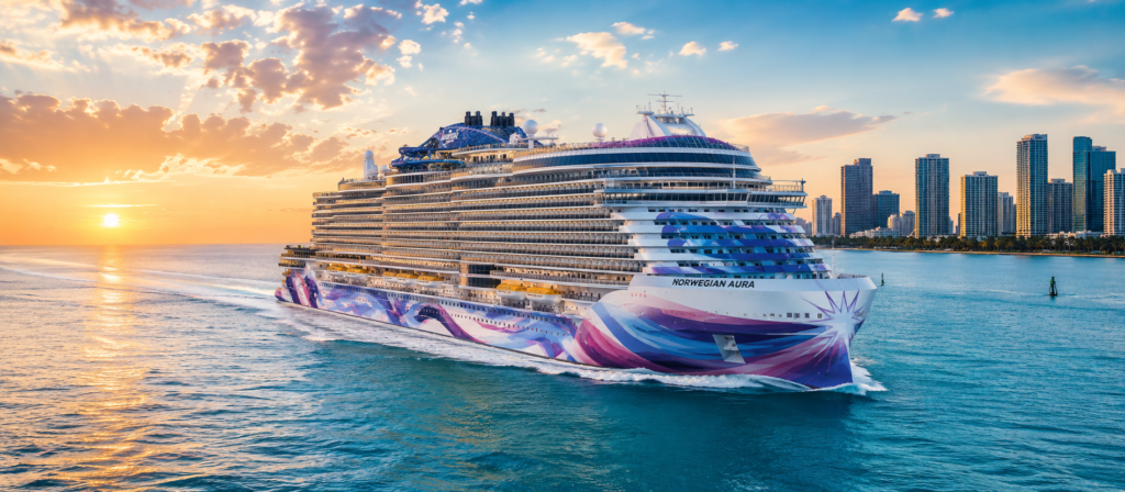 Norwegian Aura cruise ship sailing near Miami during sunset