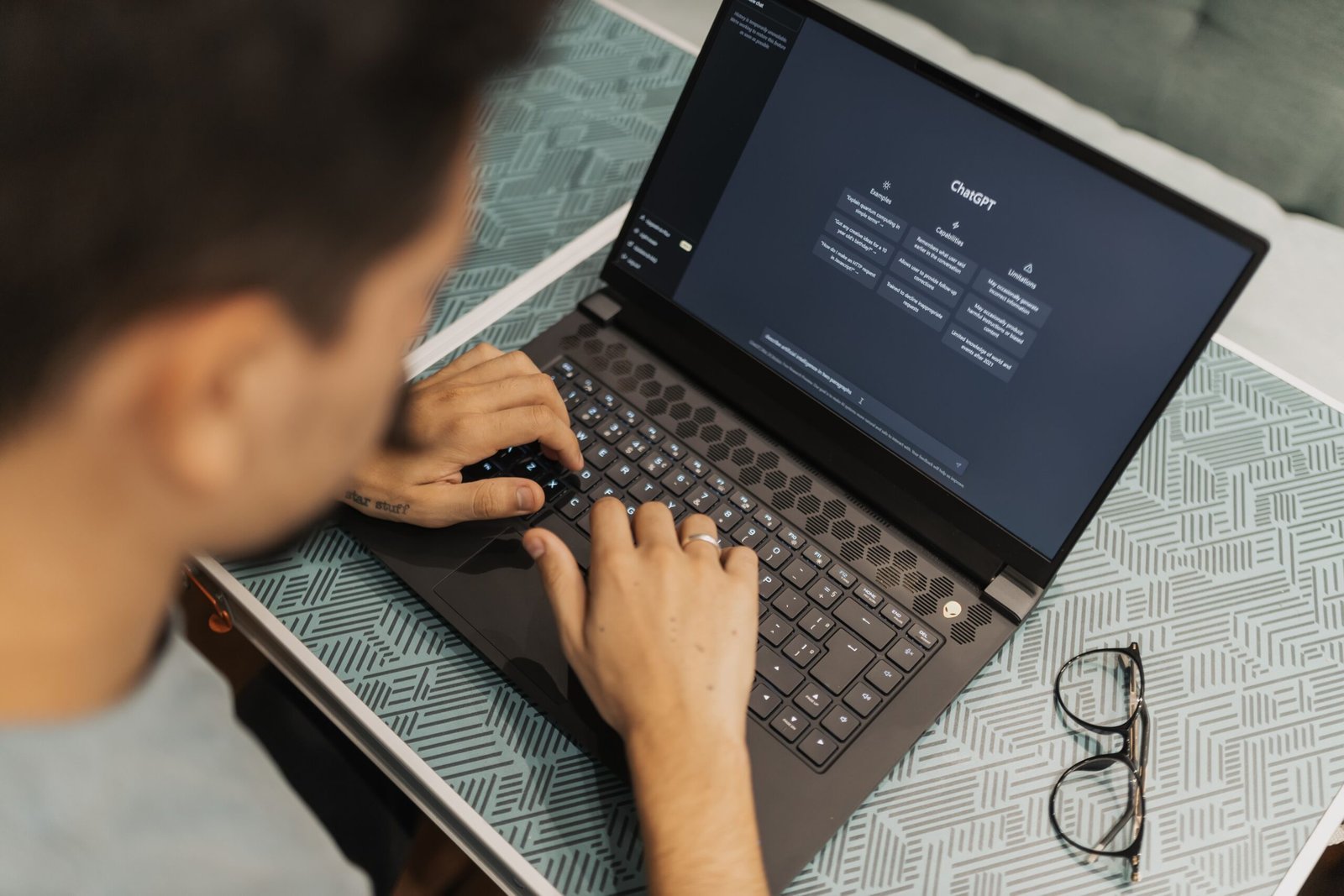 Person working with an AI assistant on a laptop in a home workspace