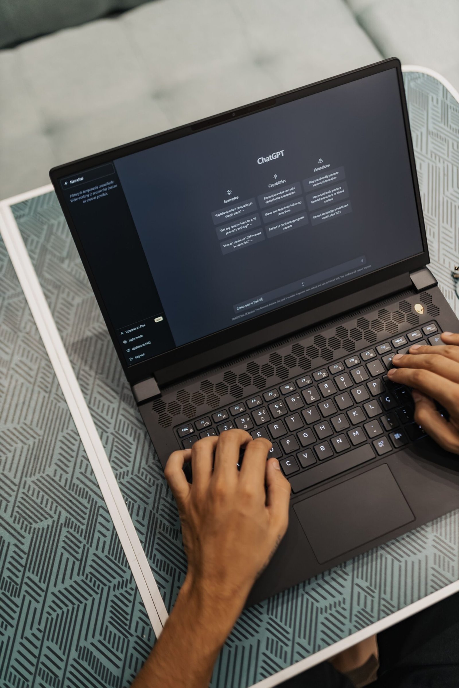 Person typing prompts into an AI assistant on a laptop
