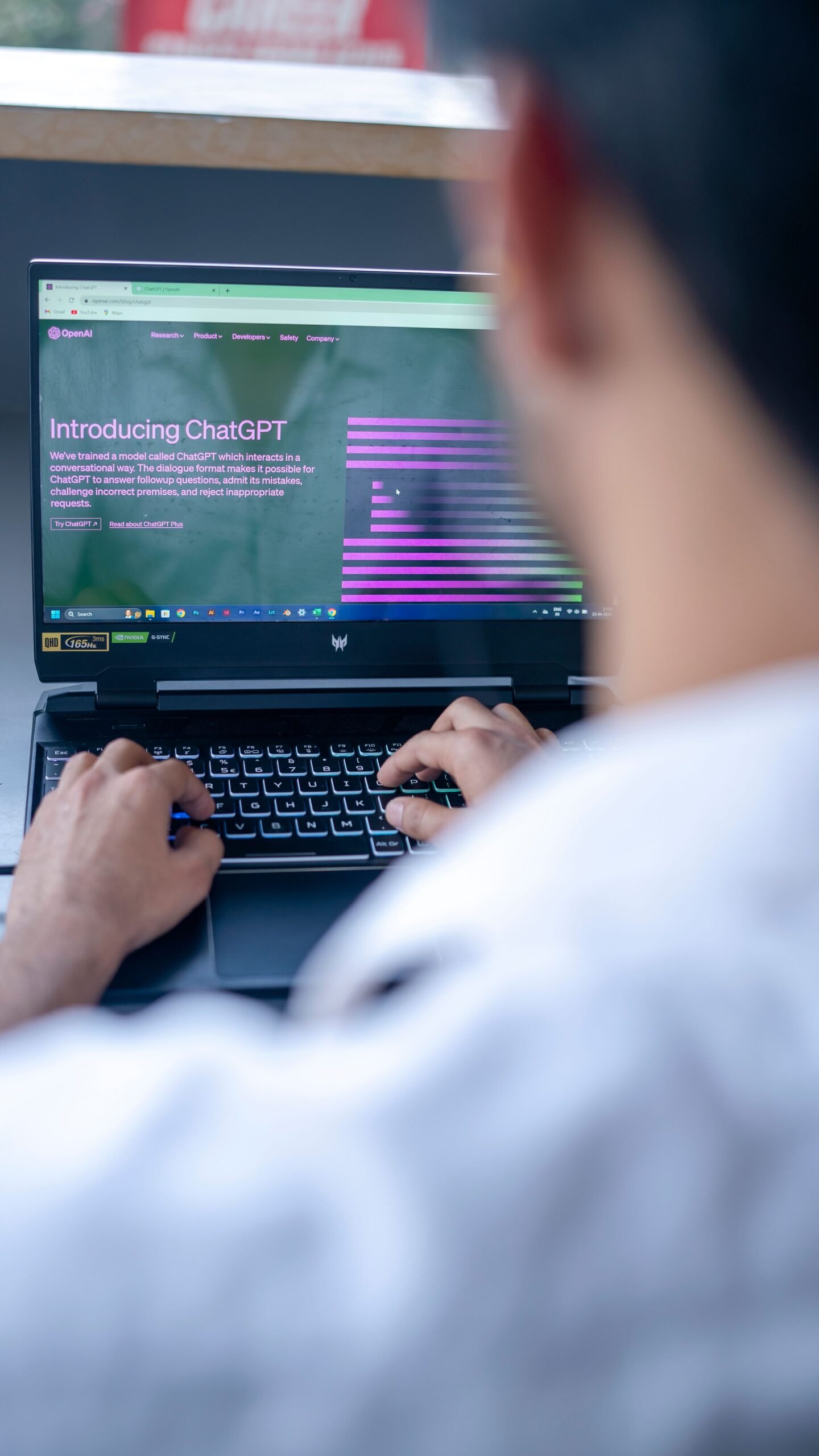 Person using ChatGPT on a laptop for AI prompting