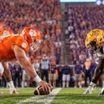 College football crowd under stadium lights for Clemson vs LSU coverage