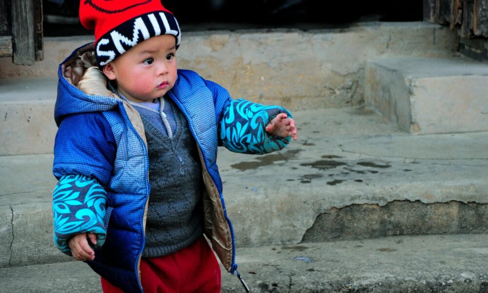 Boy wearing a casual jacket in a street style outfit