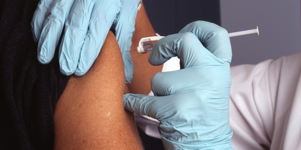 Nurse administering a vaccine during a clinic appointment
