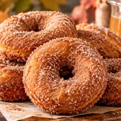 Apple cider donuts recipe with homemade cinnamon sugar donuts, fresh apples, and apple cider for a cozy fall treat.