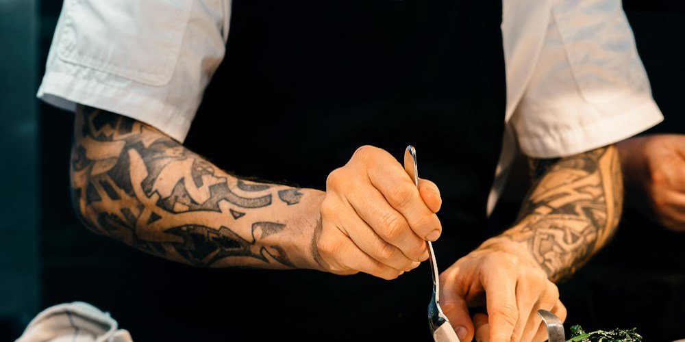 Restaurant kitchen team preparing food during service