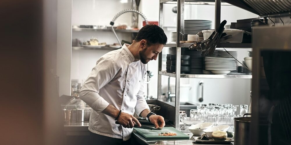 Restaurant chef working in a kitchen illustrating labor cost management